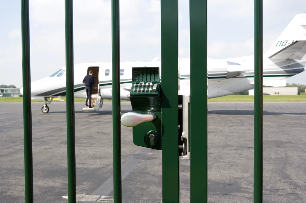 LMKQV2_SHKL__Airplane_behind_green_swing_gate_pilot_entering__1920px.webp