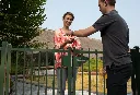 SUBY_LAKQU2_3006PC_SAKL_GBM12DP___Installer_handing_keys_at_green_fence_by_villa__1920px.webp